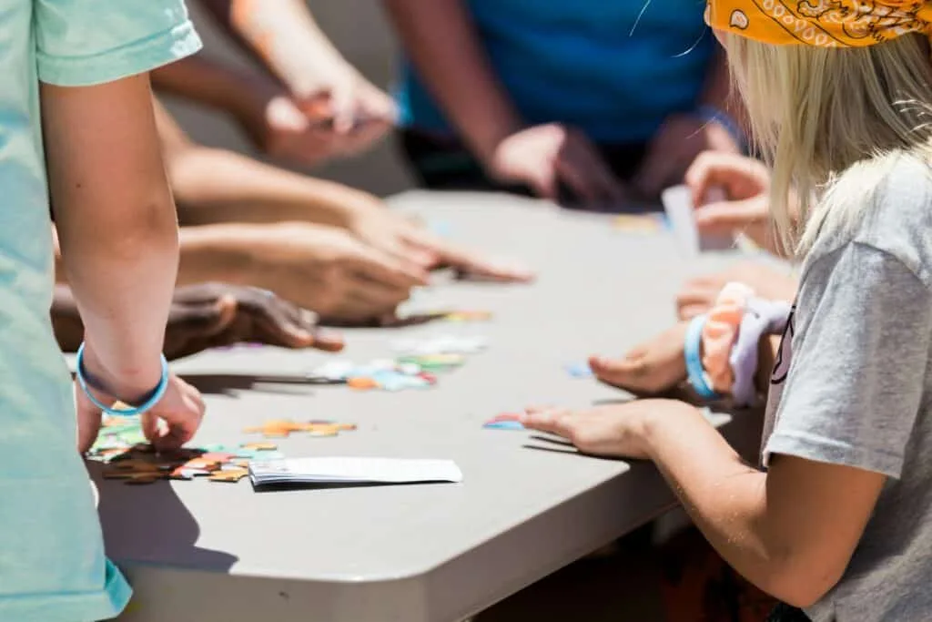 Children’s hands doing arts and crafts activity at a nursery table