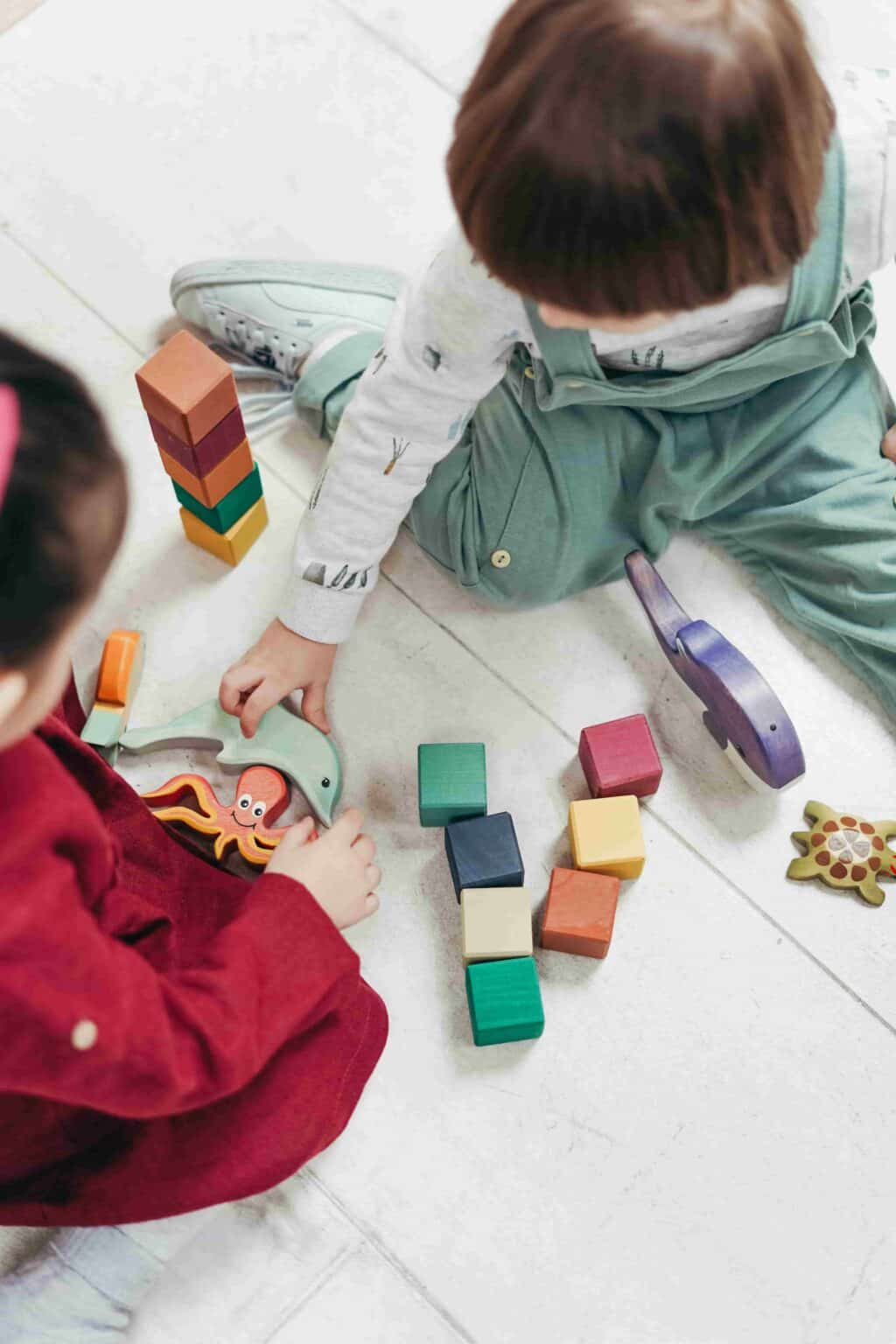 Children engaged in focused play with blocks demonstrating EYFS in-the-moment planning in nursery