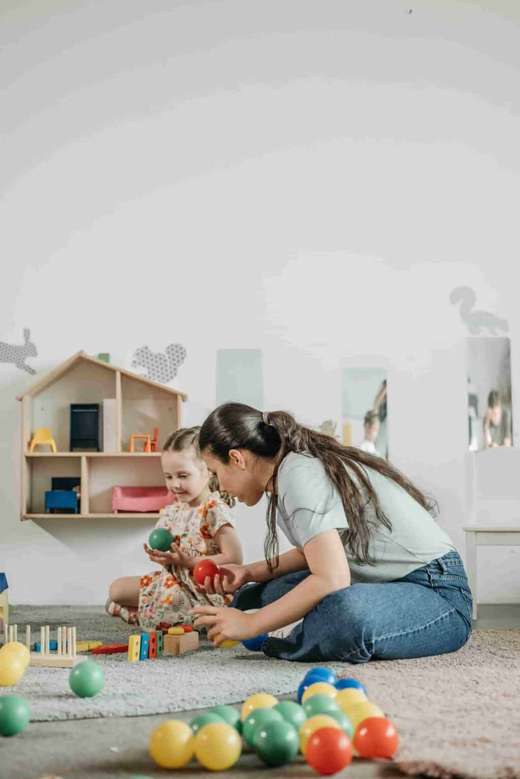 Early years practitioner supporting child through play and communication