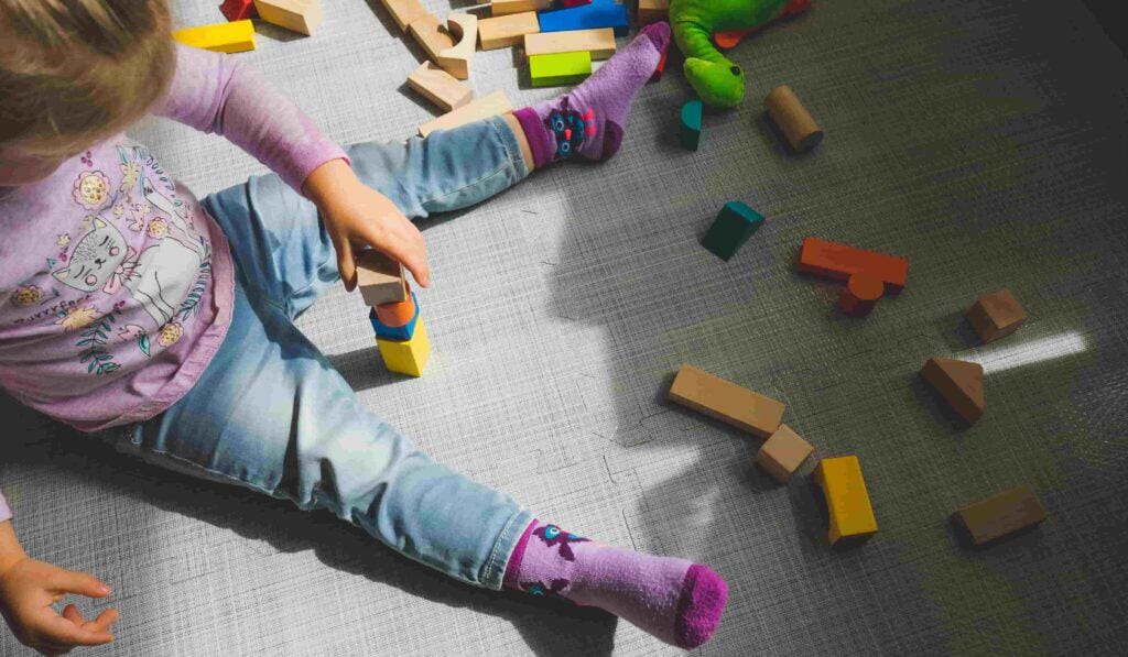 Child developing school readiness skills through play-based learning and exploration