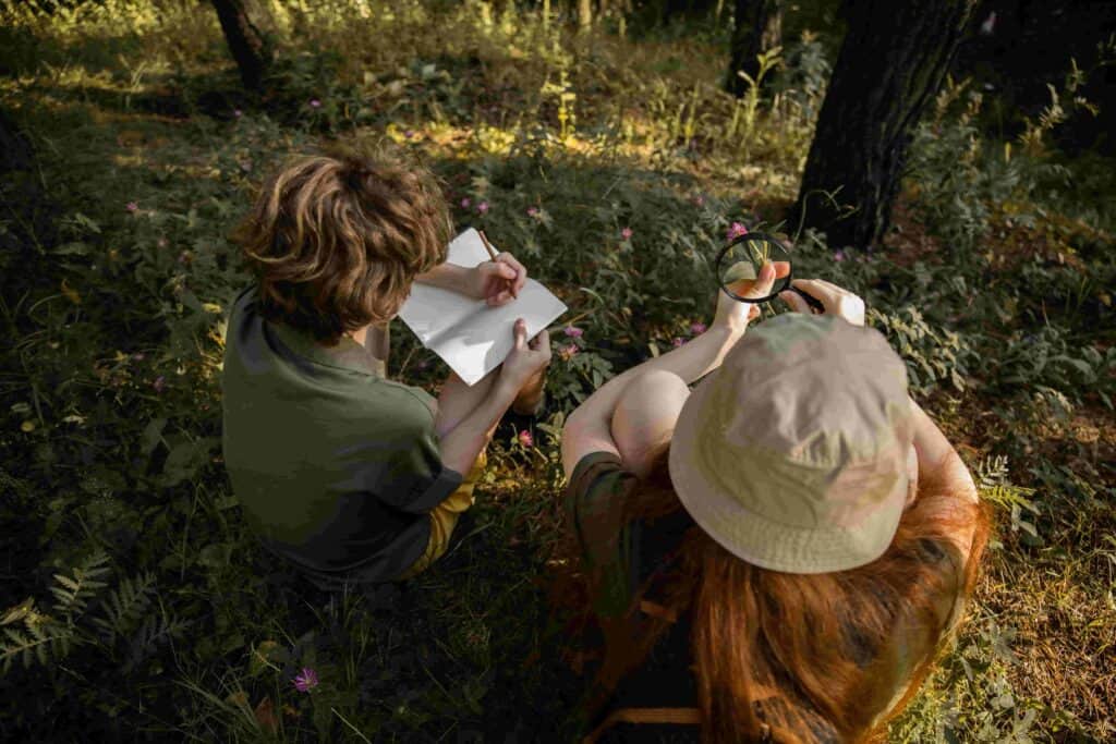 Children exploring nature outdoors with an adult